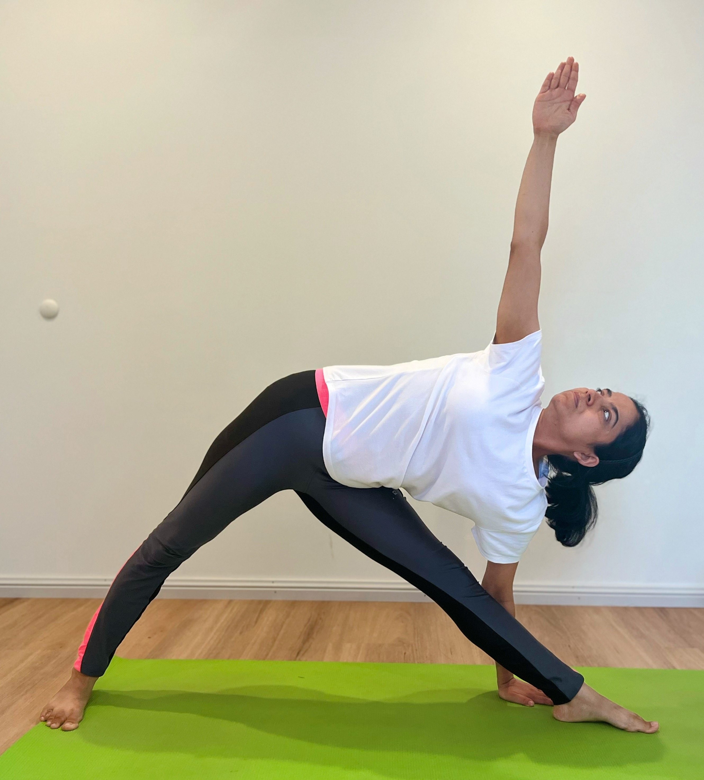 Yoga student demonstrating strength and flexibility poses during Yuj Yoga class with instructor Deepti